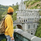 Man with backpack looking towards the Church of Las Lajas, Colombia