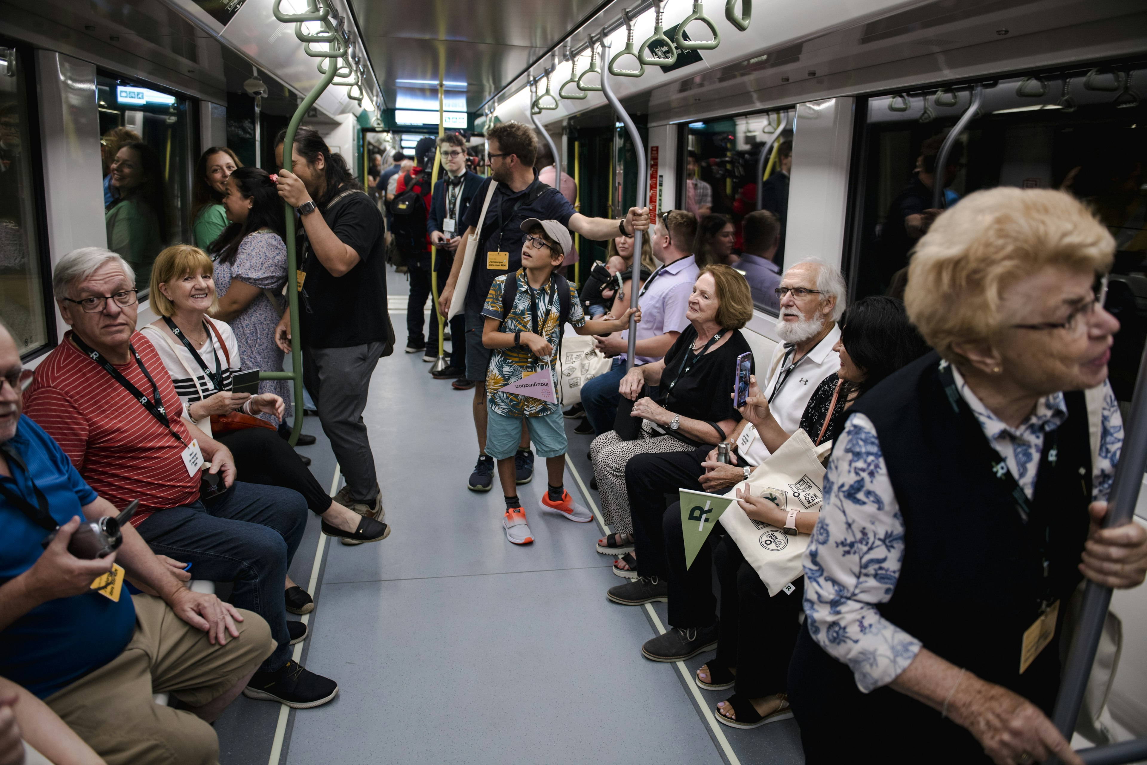 Visitors ride the Reseau Express Metropolitain (REM) light rail in Montréal, Québec, Canada