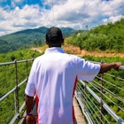 A portrait of a black man walking across a pedestrian bridge in Tennessee © Robin Gentry / Getty Images
