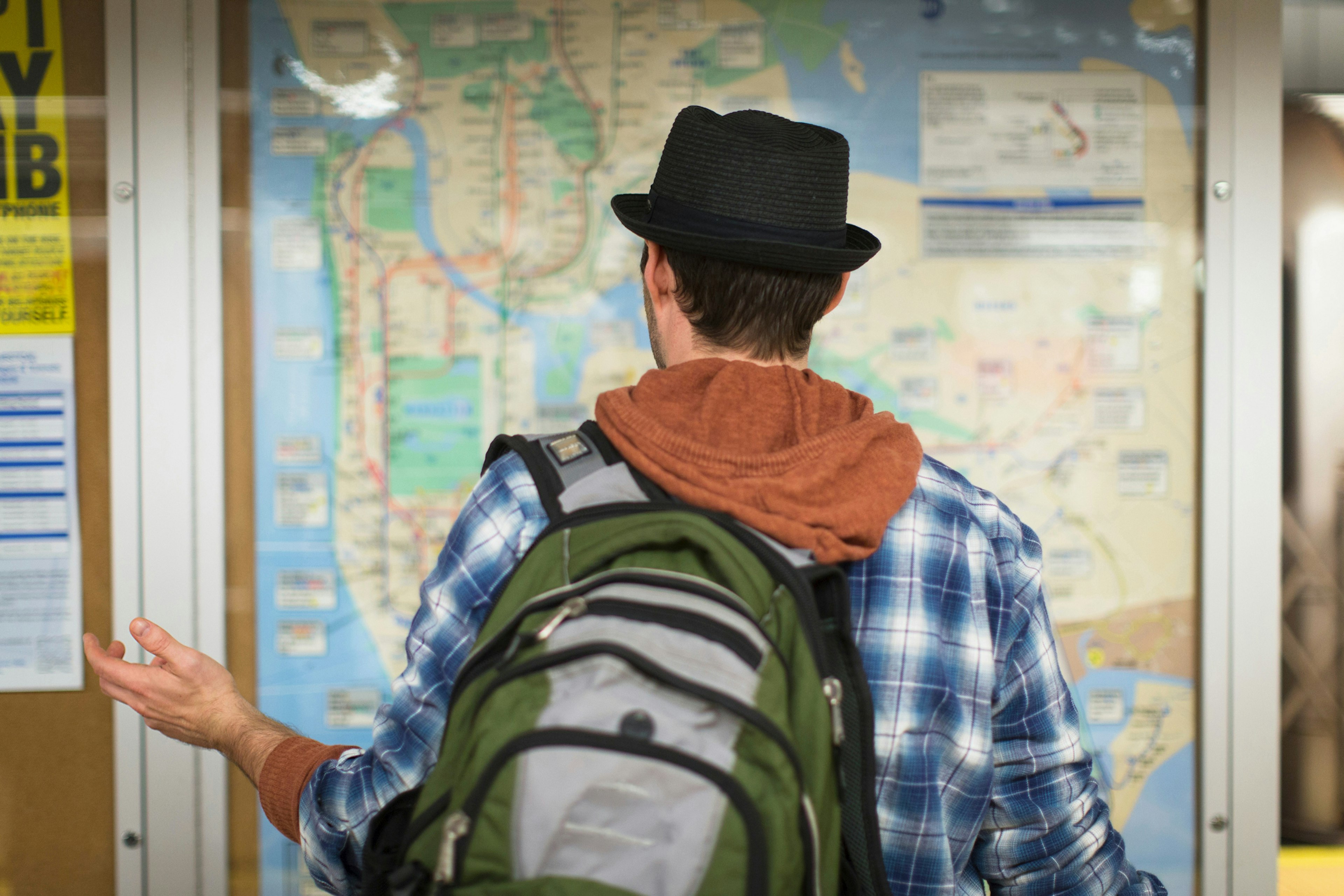 A man looking at a public transport map in New York City