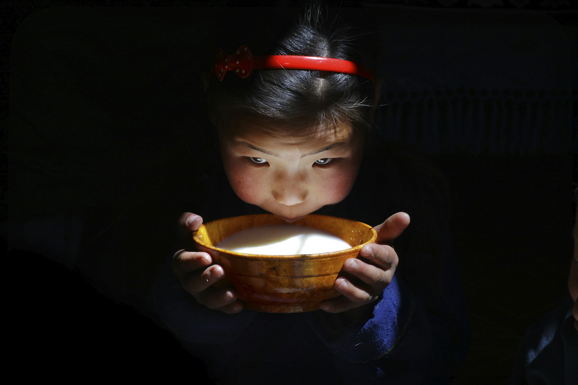 Mongolian girl drinking airag milk