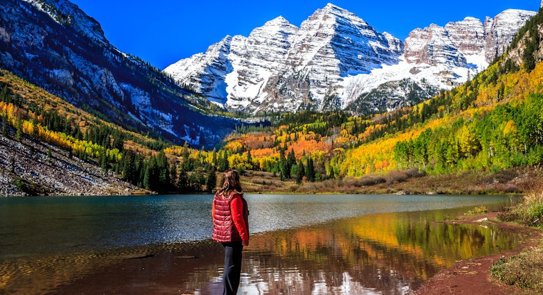 A woman stands on a rock on Maroon Lake admiring the autumnal beauty of the Maroon Bells in a sunny, cloudless day
473641514
Tourism, Wilderness Area, Morning, Non-Urban Scene, Extreme Terrain, Women, Females, Elk Mountains, National Forest, Maroon Lake, Snowcapped, Maroon Bells, Aspen Tree, Scenics, Rocky Mountains, Majestic, Idyllic, Tranquil Scene, Famous Place, High Up, Nature, Outdoors, Colorado, Western USA, USA, Leaf, Reflection, Alpenglow, Autumn, Mountain Peak, Mountain, White River National Forest, Forest, Landscape, Lake, Glacier, Snow, North Maroon Peak, South Maroon Peak