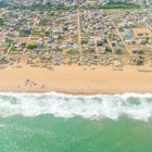 Aerial view of the Atlantic Ocean coastline along the shores of Cotonou, Benin
478055884
Coastline, Aerial View, People, Benin, Africa, Day, Beach, Atlantic Ocean, Sea, Cotonou
Benin