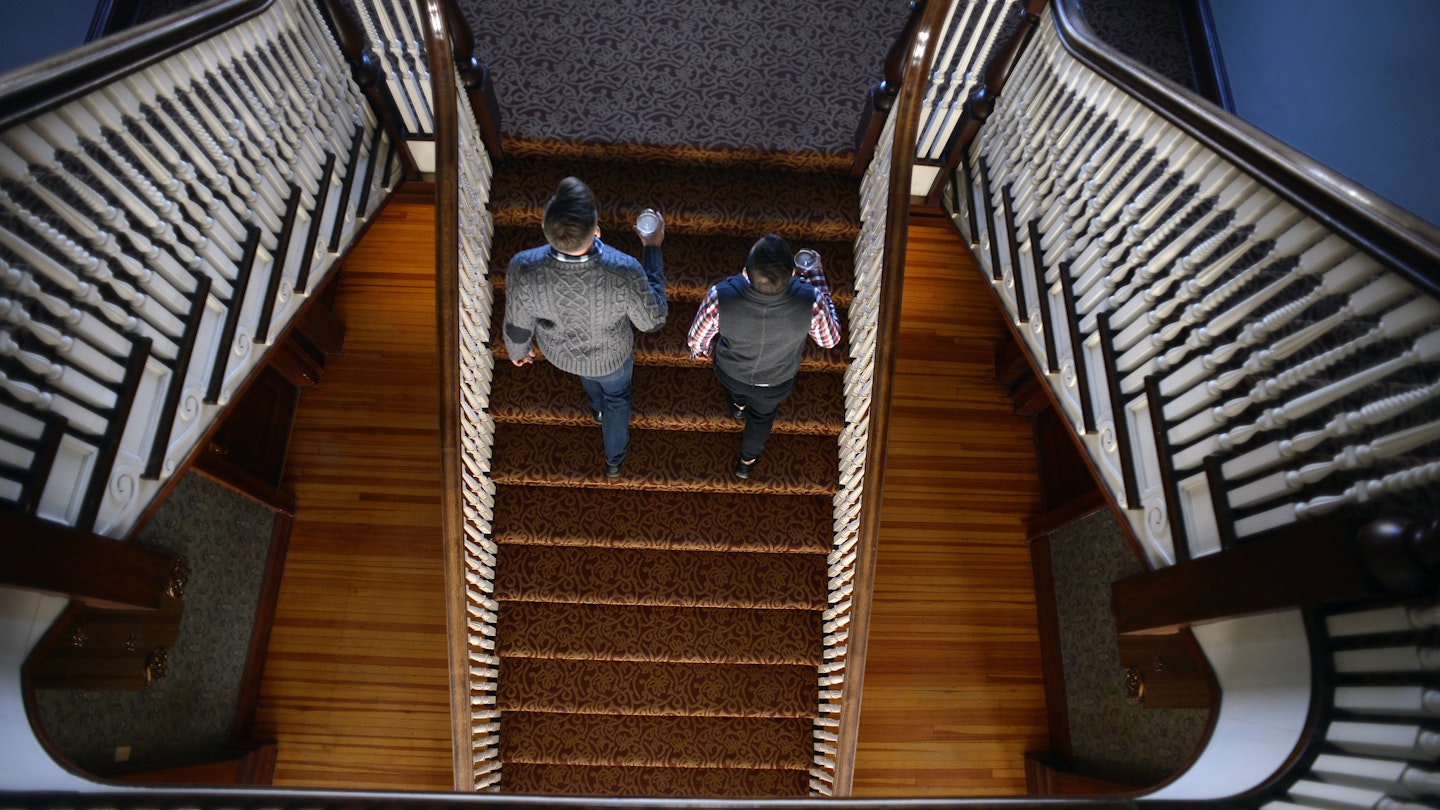ESTES PARK, CO - JANUARY 12: Visitors Landen Jones, left, and Joshua Potter, who are staying at the hotel for the week, walk up the grand staircase in the Stanley Hotel on January 12, 2016 in Estes Park, Colorado.  The Stanley Hotel, which first opened in 1909, and known for its architecture, magnificent setting, and famous visitors, may possibly be best known today for its inspirational role in the Stephen King's novel, "The Shining." This Colorado hotel has been featured as one of America's most haunted hotels and with the numerous stories from visitors and staff. (Photo by Helen H. Richardson/The Denver Post via Getty Images)
504798066