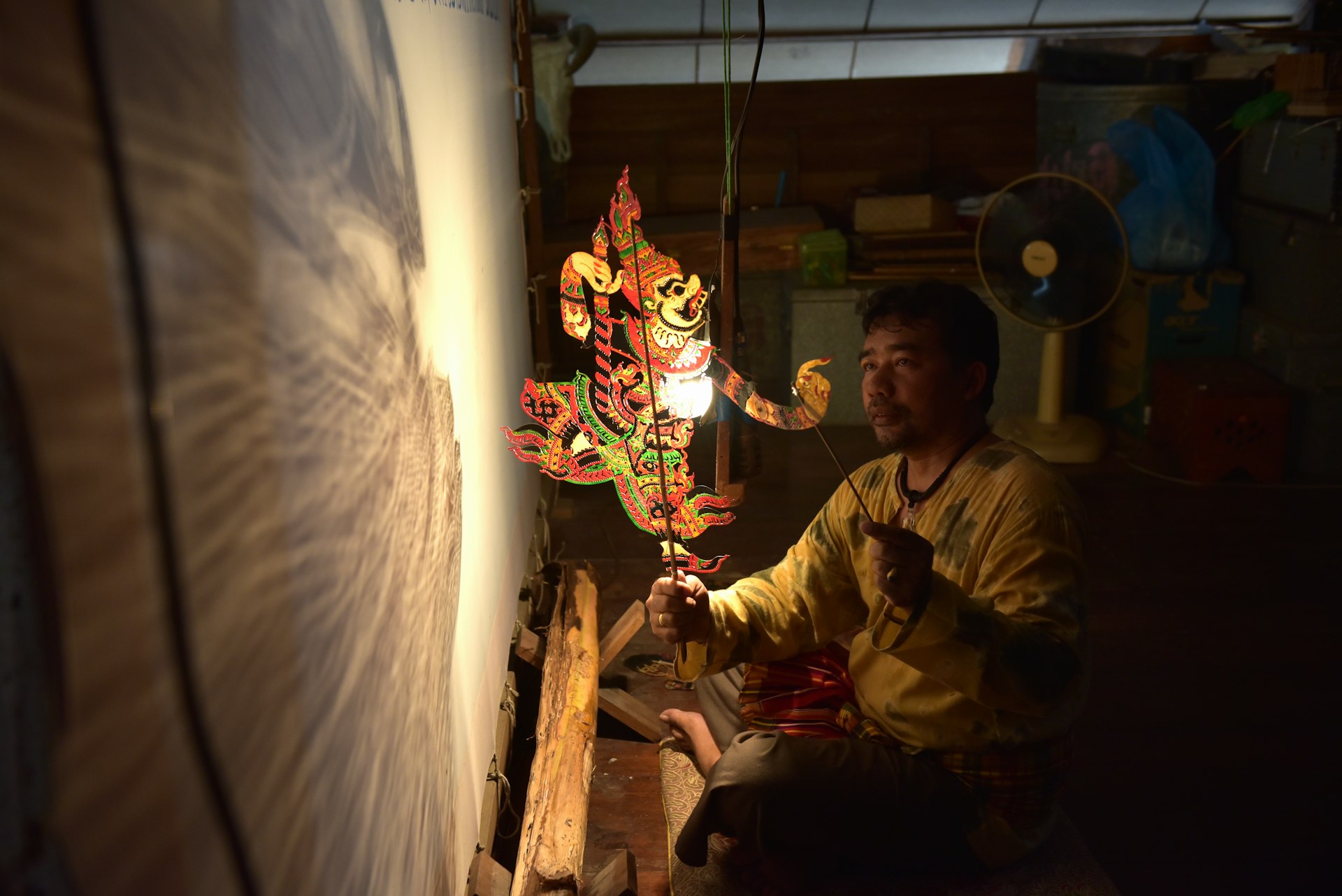 A man performs traditional Nang Talung shadow puppetry, Thailand