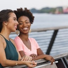 Two women laughing on a bridge in Philadelphia