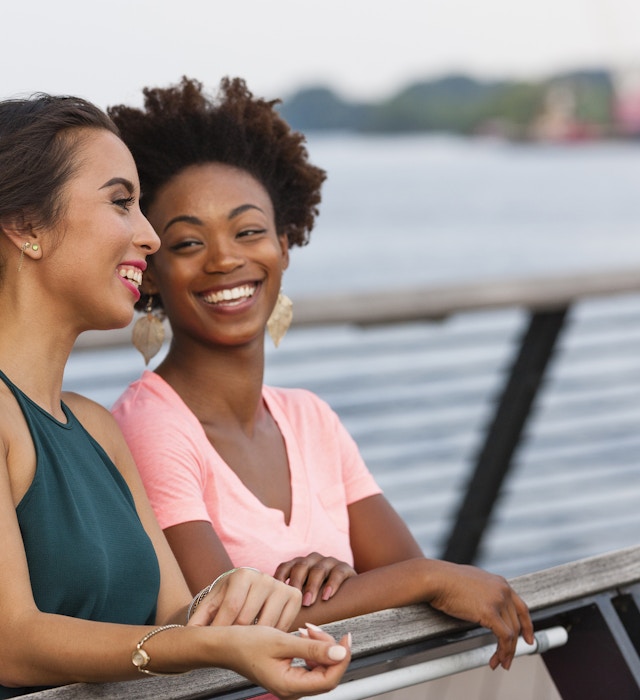 Two women laughing on a bridge in Philadelphia