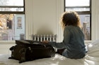 Female solo traveller sat on bed with suitcase looking out of the window in Brooklyn, New York.
599473197
Travel, Independence, Contemplation, Wanderlust, Traveller
