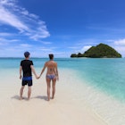Palau - July 2017: young couple enjoying the view on Long Beach with one of the many islands of Palau in the background, surrounded by clear water in turquoise and blue colors
854284974
A couple standing on Long Beach in Palau surrounded by clear blue ocean and islands in the background.