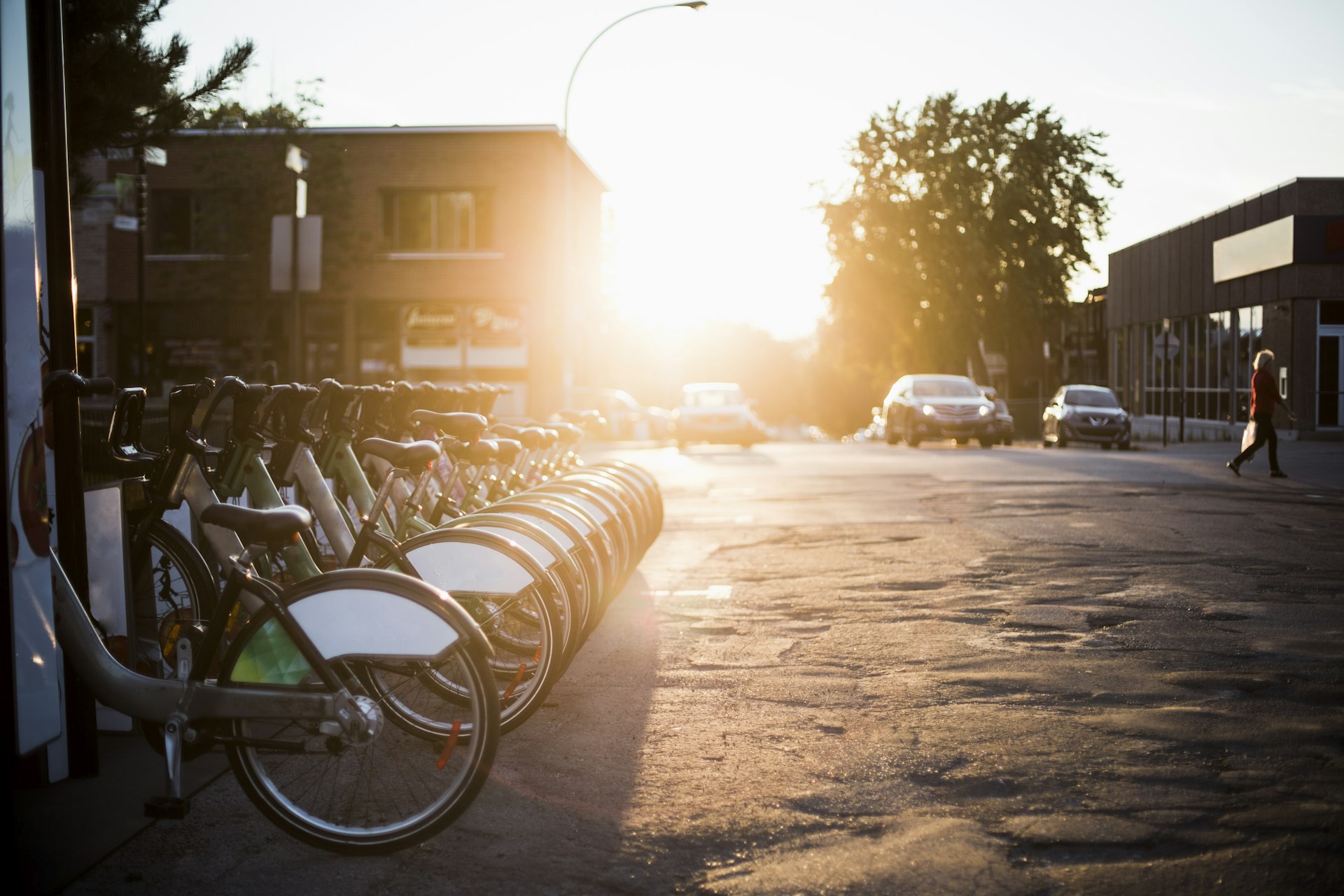 Public bikes sit in their racks at sunset in Montreal