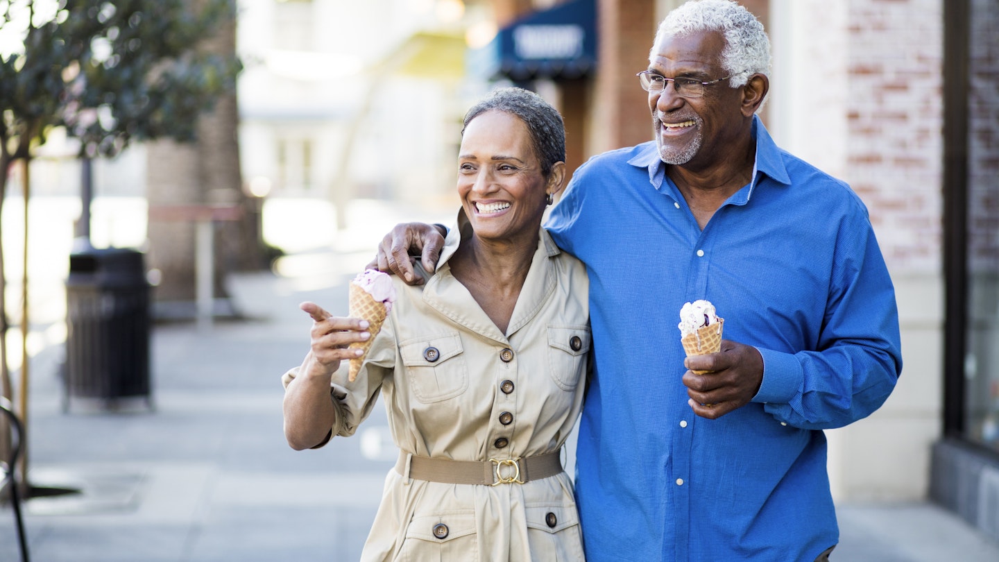 A senior african american couple enjoy an evening on the town with ice cream
898247966
A smiling couple walking along the street while eating ice cream in California