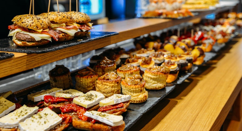 Spanish tapas called pintxos of the Basque country served on a bar counter in a restaurant in San Sebastian, Spain
988641314
pintxo, closeup, nobody, gastronomy, gastronomic, aubergine, colourful, crusty, dish, party, pinchos, finger food, spanish food, basque country, aperitivo, bokeh, pinchado, board, tasty, tomatoes, artificial light, group, pintxos