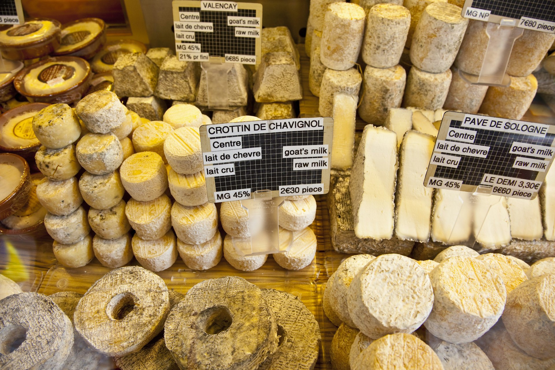Various kinds of cheese for sale at a street market on Rue Mouffetard in Paris