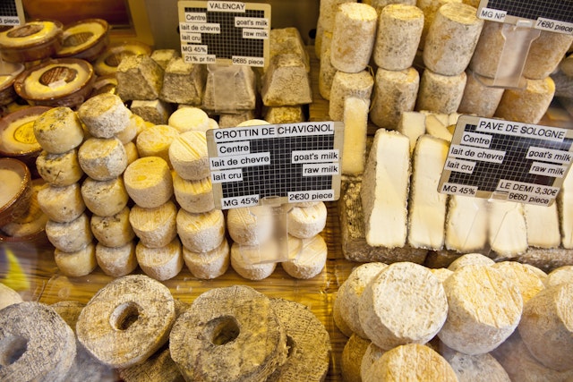 Various kinds of cheese for sale at a street market on Rue Mouffetard in Paris