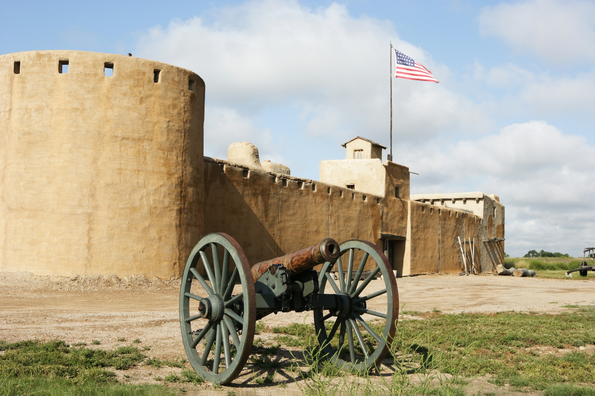 A cannon in front of the solid walls of Bent's Old Fort National Historic Site