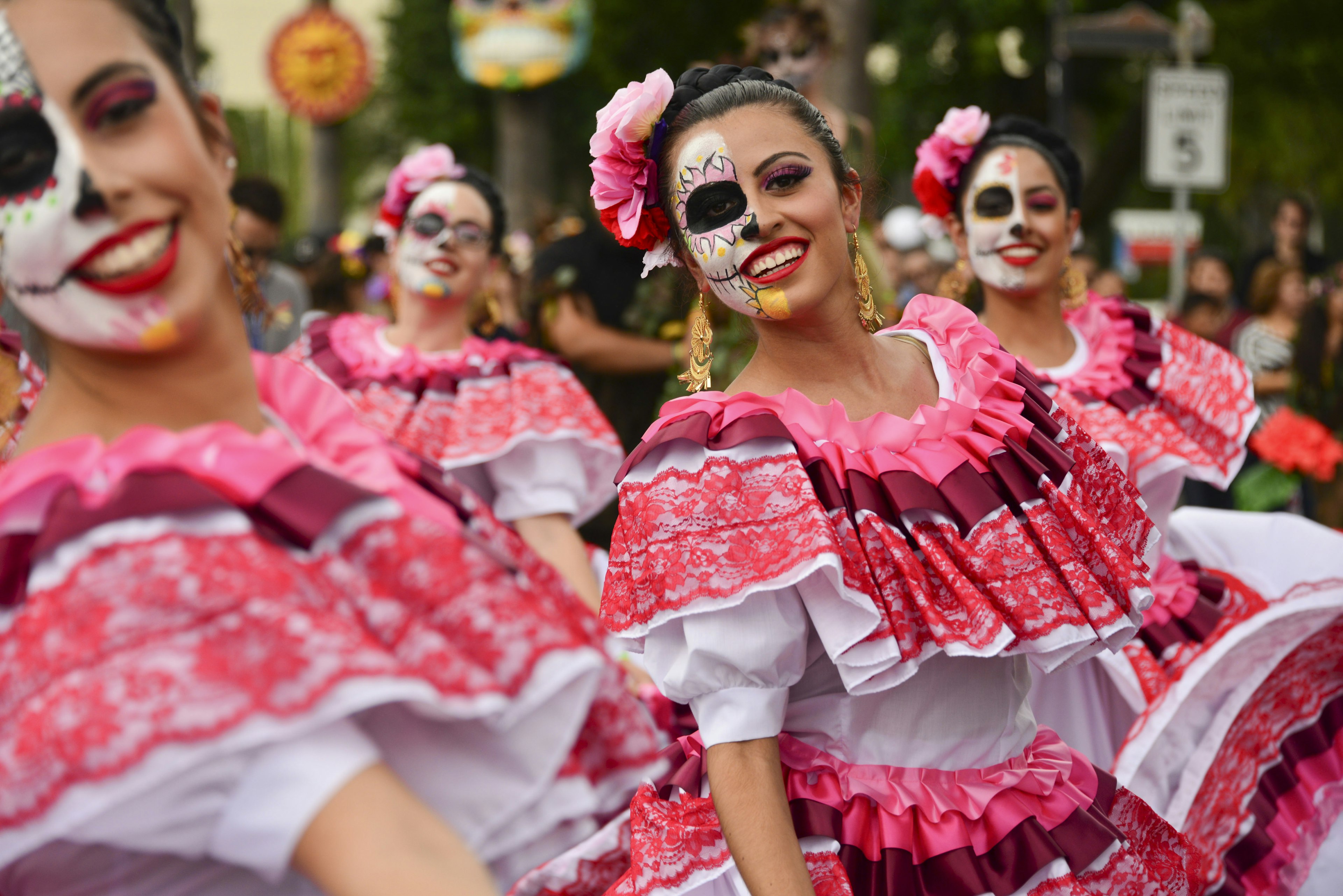 Hispanic and Latin American women celebrate Day of the Dead in a parade at Hollywood Forever Cemetery