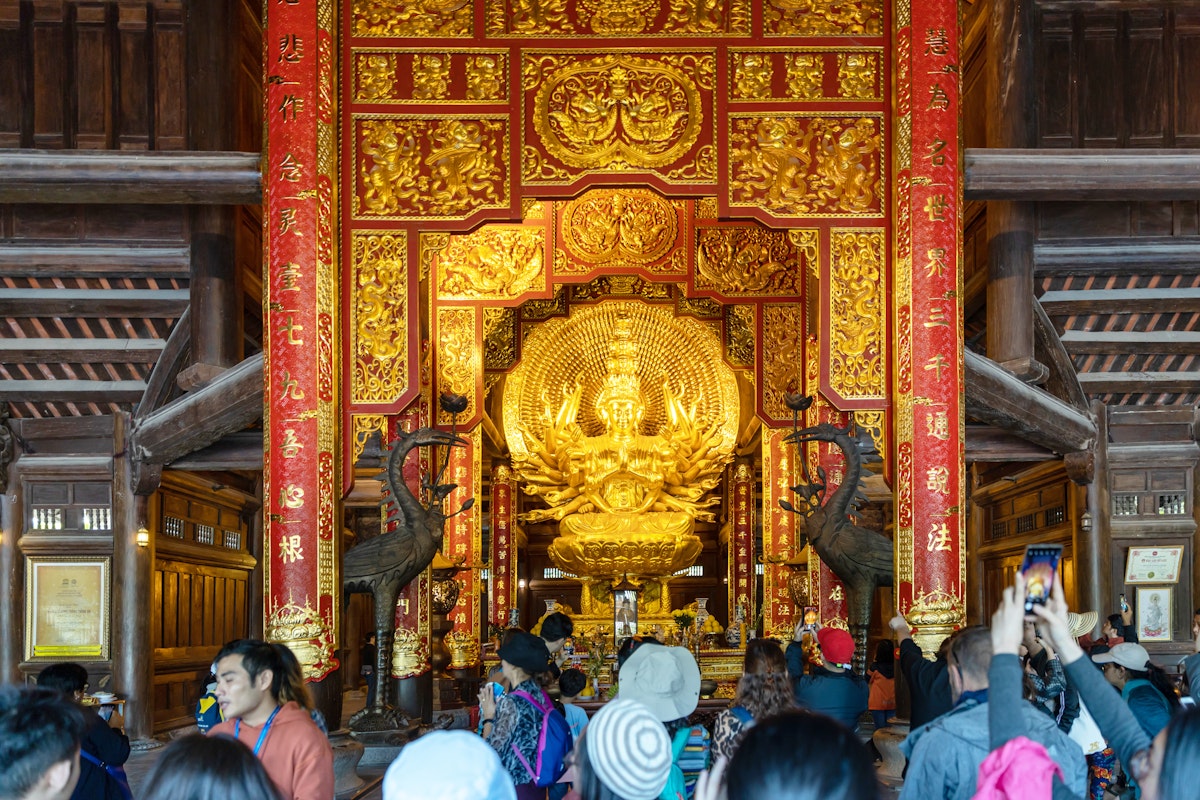 Interior view of building with golden sculpture at Chua Bai Dinh Pagoda is the largest complex of Buddhist temple in country.