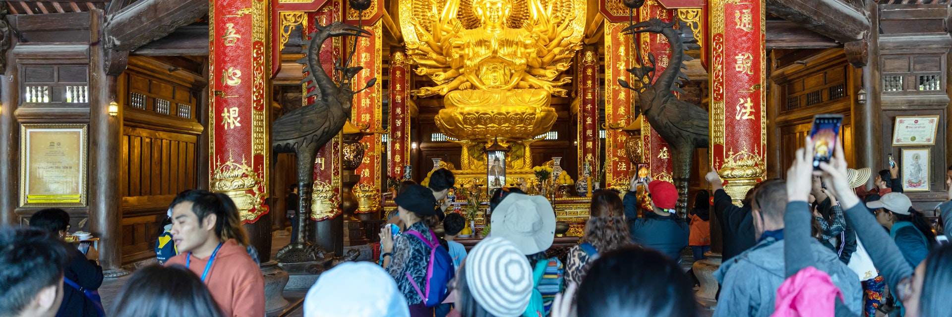 Interior view of building with golden sculpture at Chua Bai Dinh Pagoda is the largest complex of Buddhist temple in country.