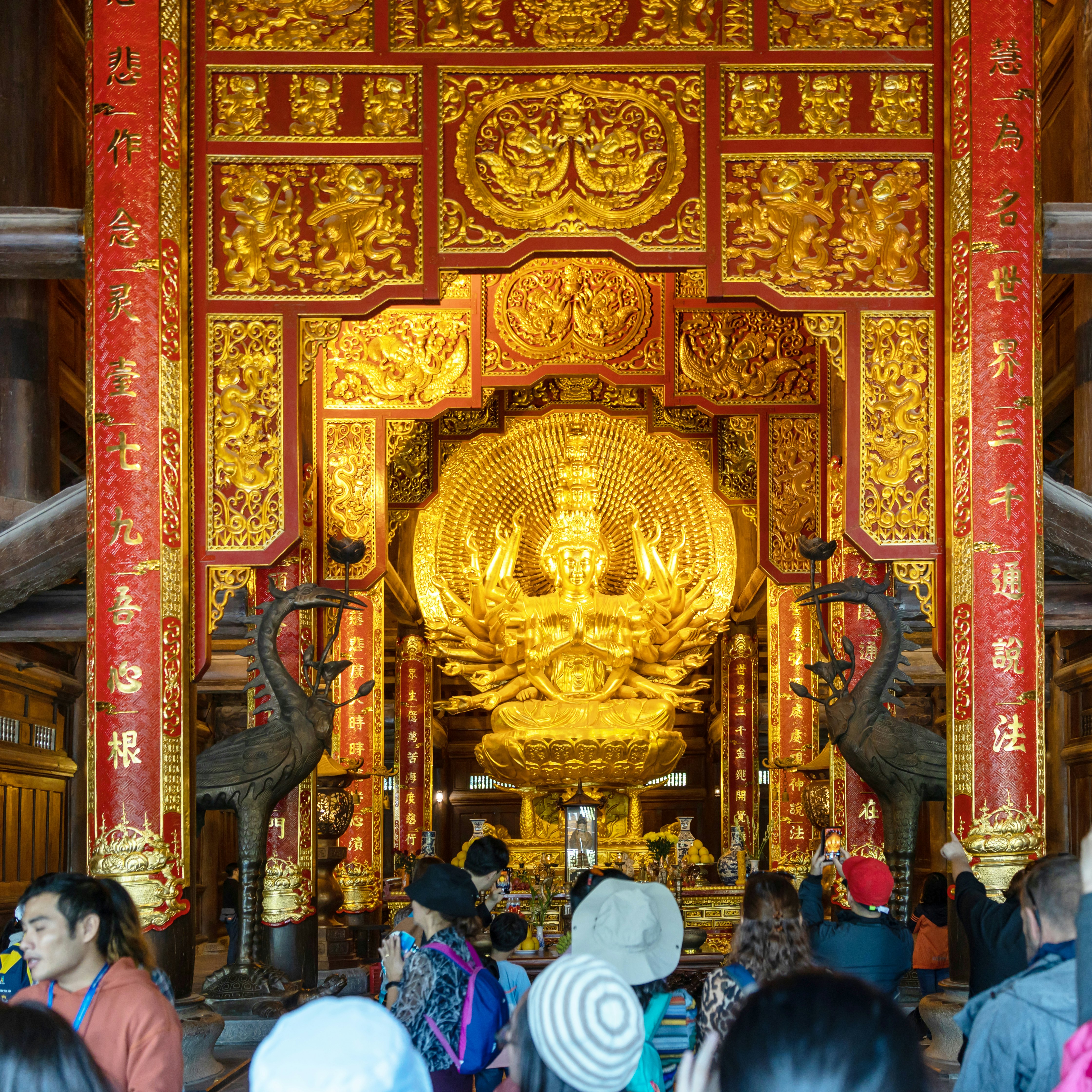 Interior view of building with golden sculpture at Chua Bai Dinh Pagoda is the largest complex of Buddhist temple in country.