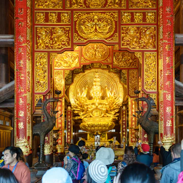 Interior view of building with golden sculpture at Chua Bai Dinh Pagoda is the largest complex of Buddhist temple in country.