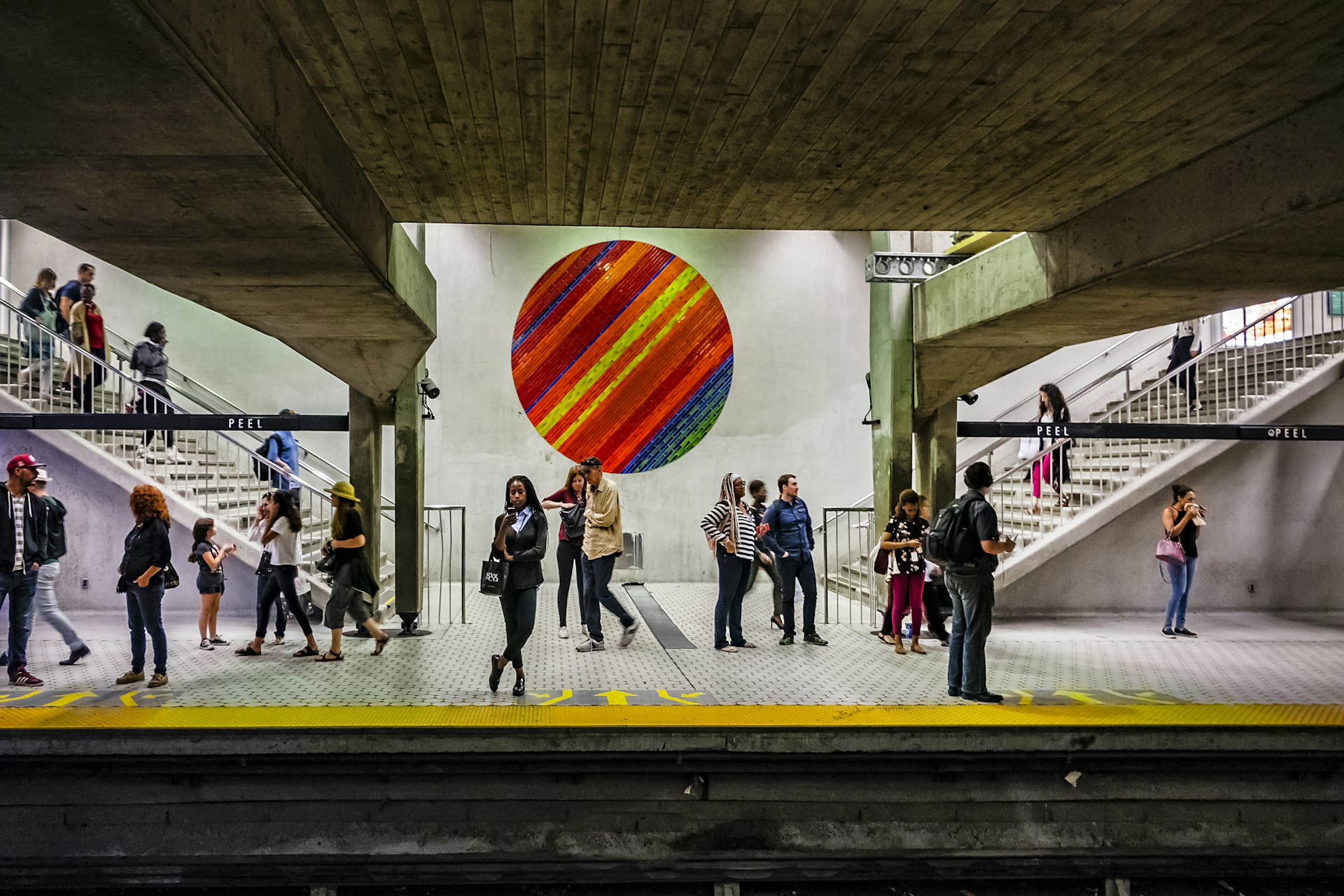 People wait on a subway station platform in Montréal, Québec, Canada