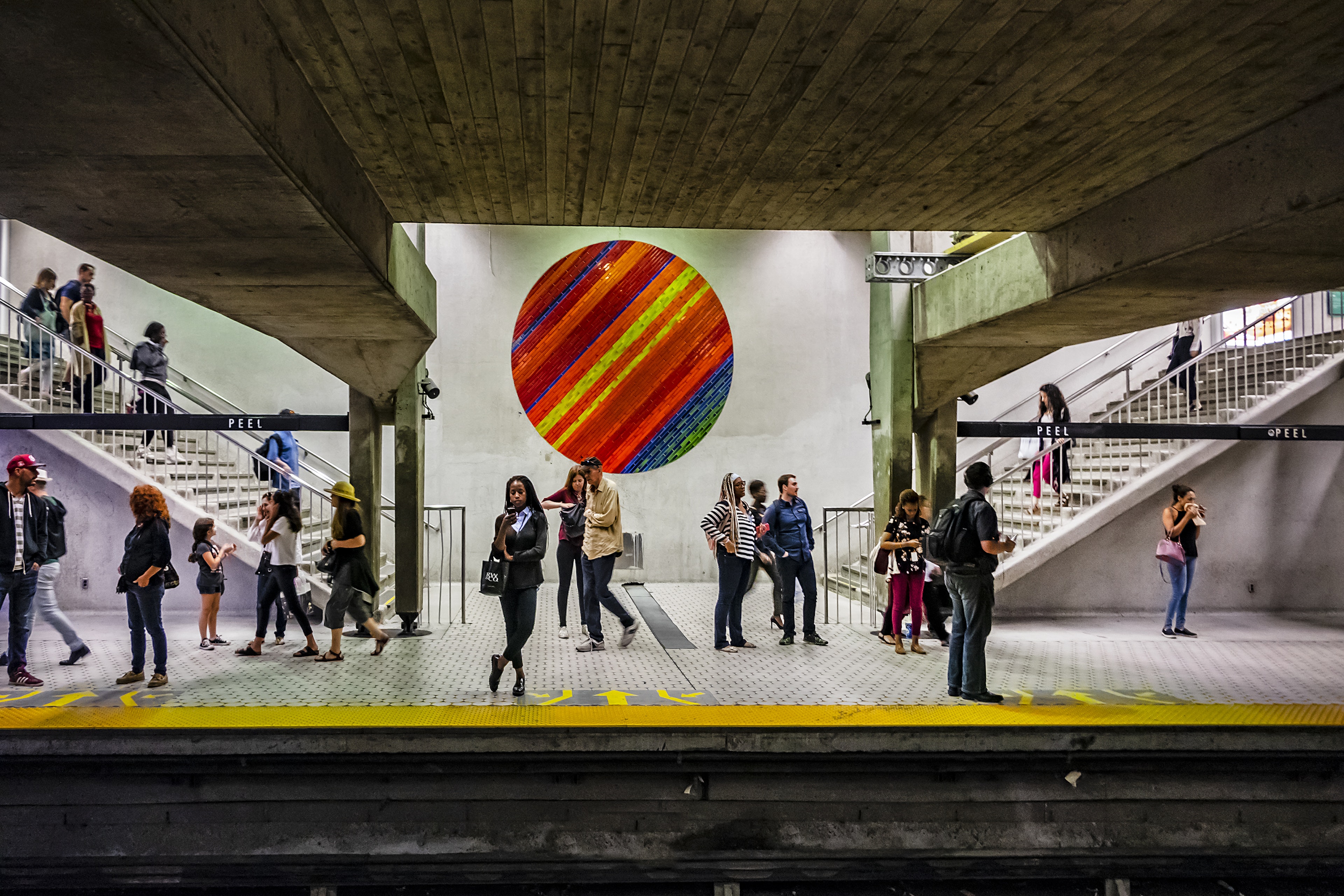 People wait on a subway station platform in Montréal, Québec, Canada