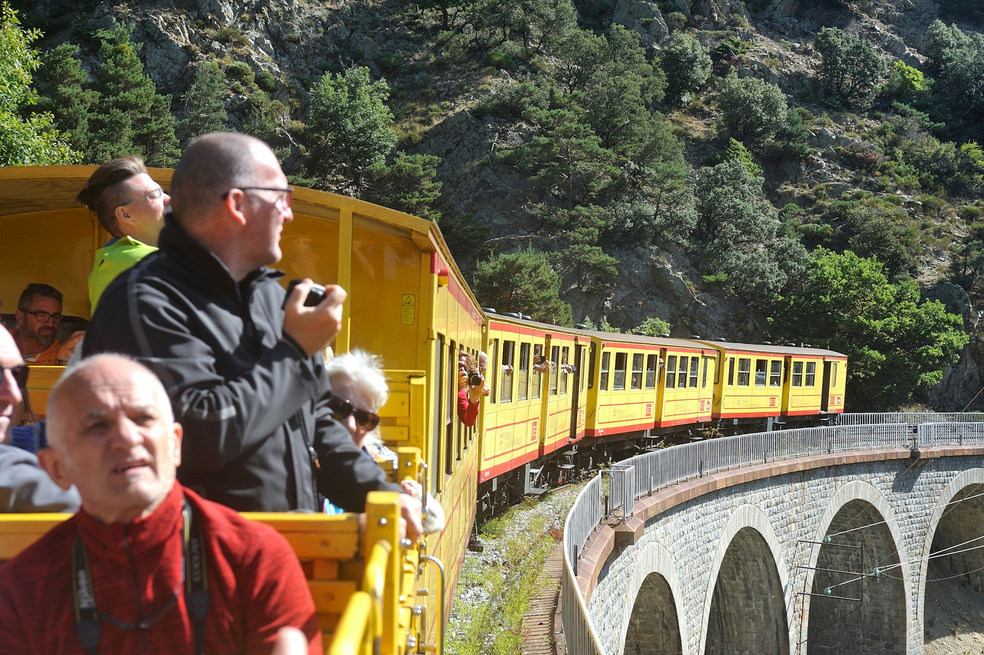 Passengers on the Small Yellow Train in the Pyrenees, France