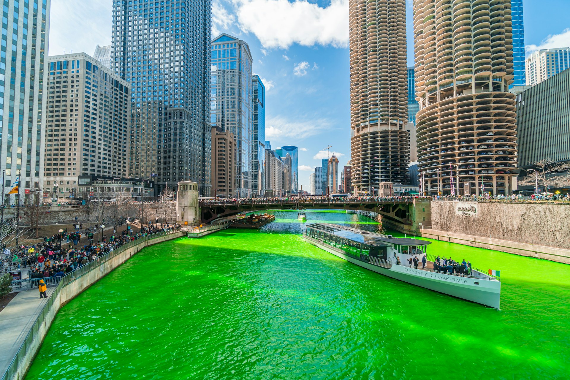 A boat on the Chicago River, dyed green for St Patrick’s Day, Chicago, Illinois, USA