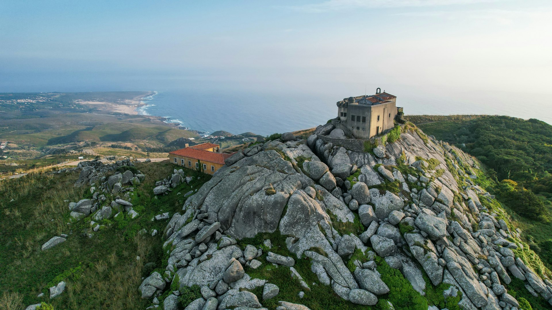 An aerial view of Santuário da Peninha, which sits on a mountain on the coast in Sintra