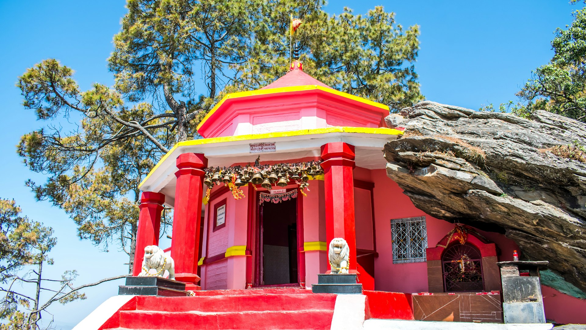 The famous Kasar Devi Temple, a pink-colored Hindu shrine