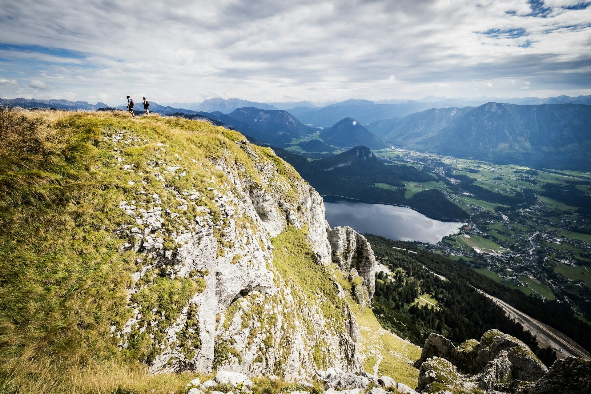 Two mountain climbers on a ridge on the way up to the summit of Loser mountain, Altaussee, Austria