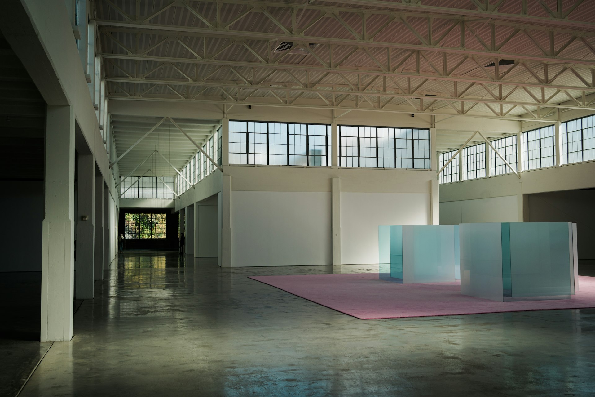 The interior of a large factory space converted into a modern art gallery