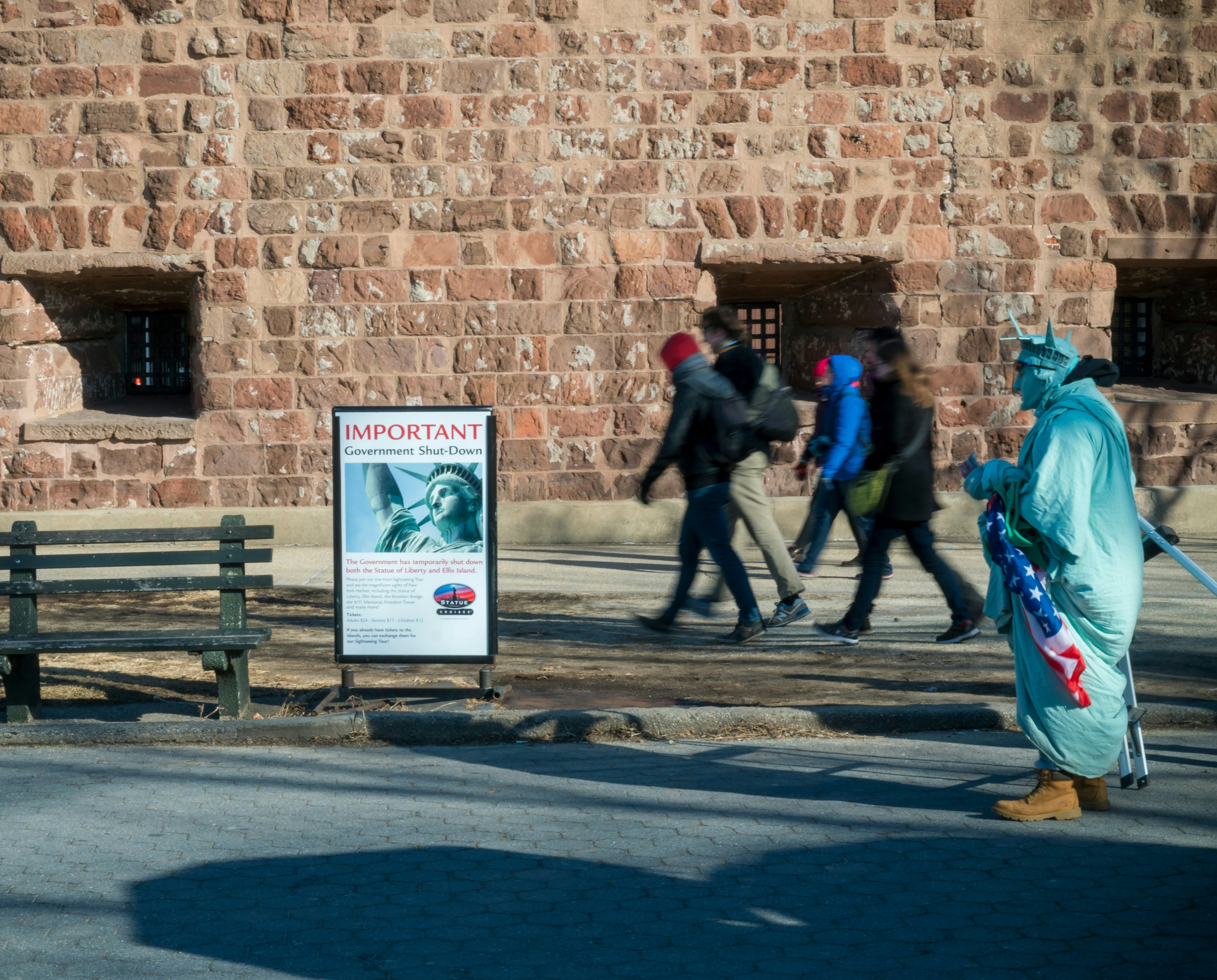 Visitors to the Statue of Liberty and Ellis Island are confronted with a sign informing them that the monuments are closed due to the government shutdown