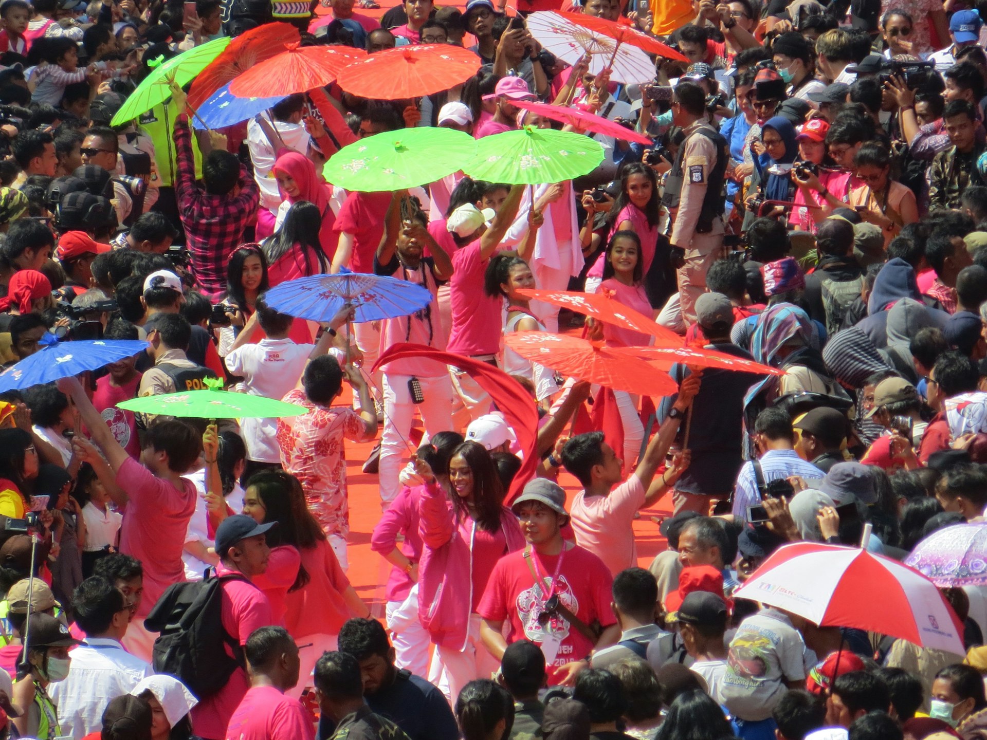 Carnival crowds with colorful parasols in Glodok, Jakarta's Chinatown