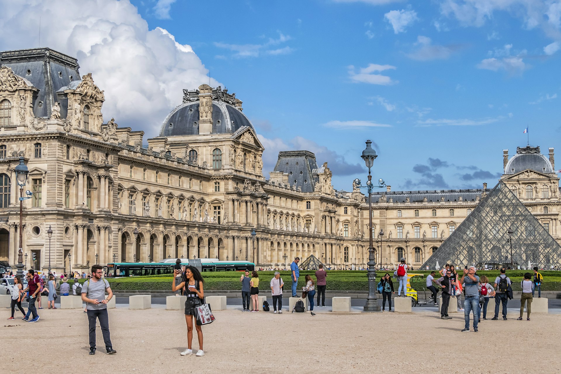 Visitors crowd around the Louvre's main courtyard (Cour Napoleon) in Paris