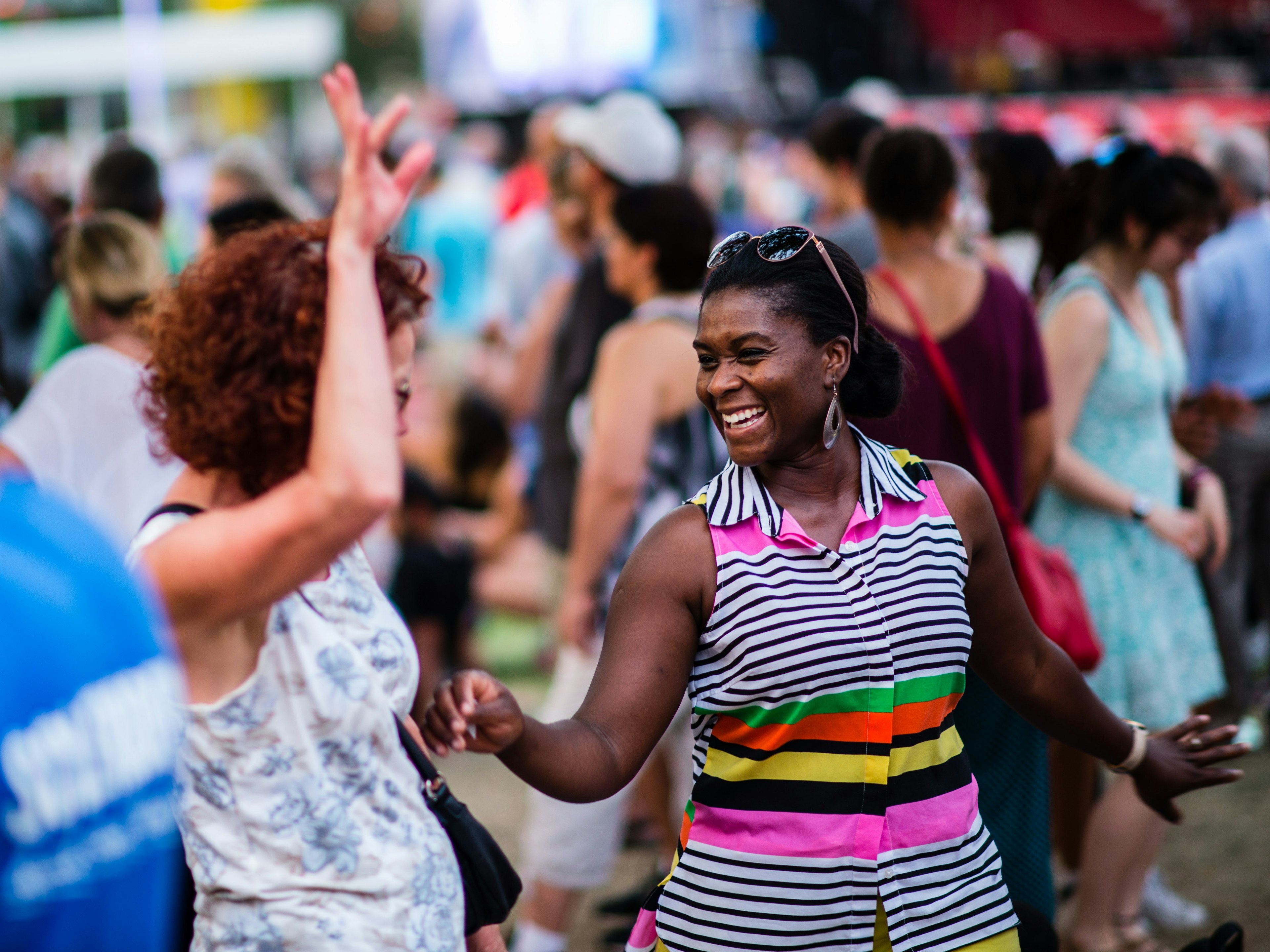 People dancing and enjoying an outdoor concert at Place des Arts in Montreal.