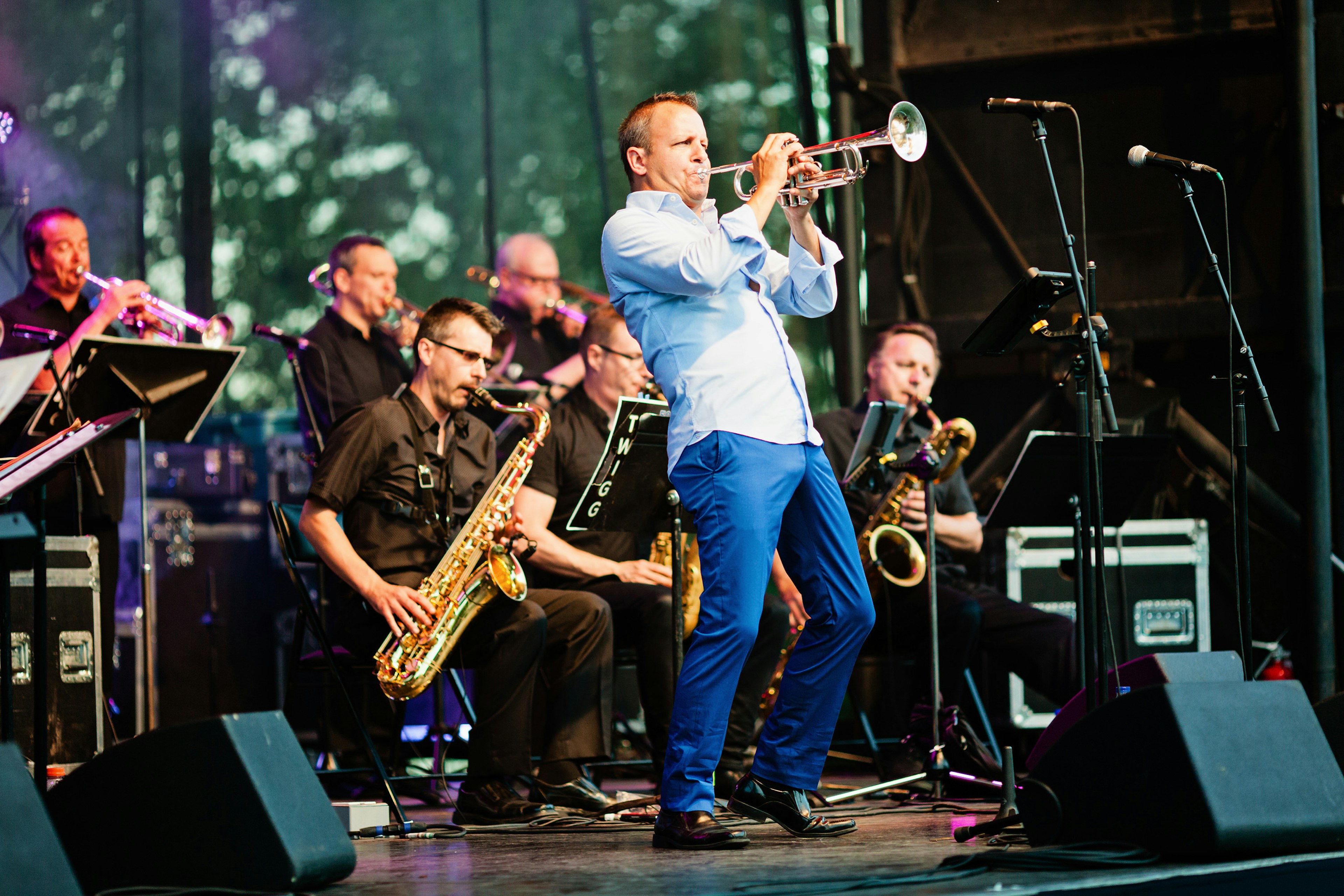 A man plays a trumpet as part of a jazz band playing a tribute to Maynard Ferguson during a free public jazz concert at the park in Montreal