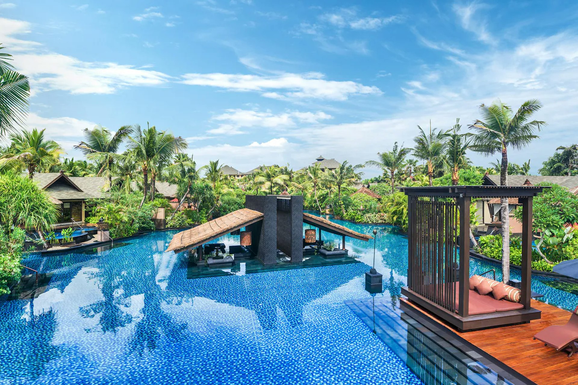 The lagoon pool at the St Regis Bali, with palm trees and sun porches
