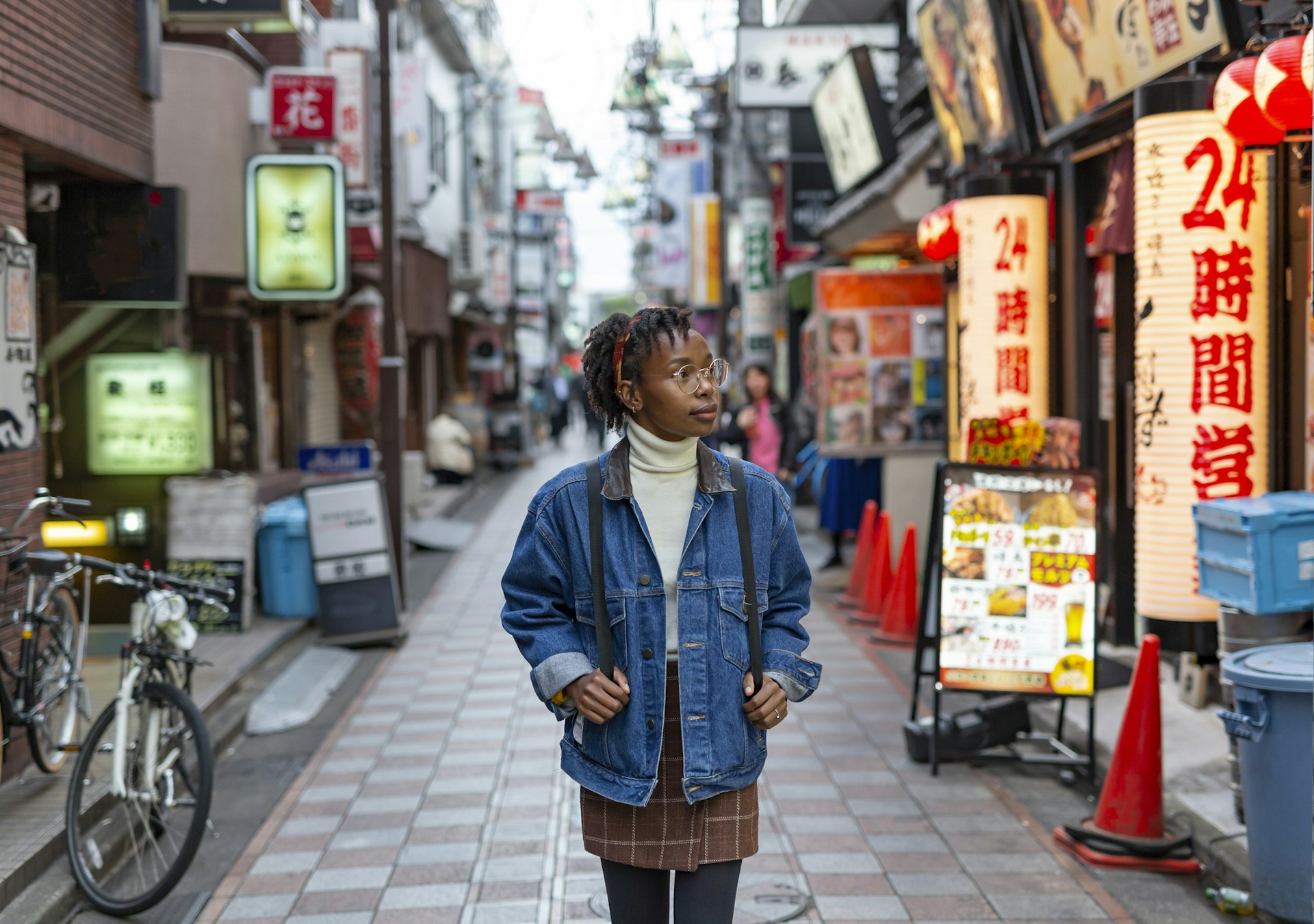 Portrait of a happy woman walking along a quiet street in Tokyo 