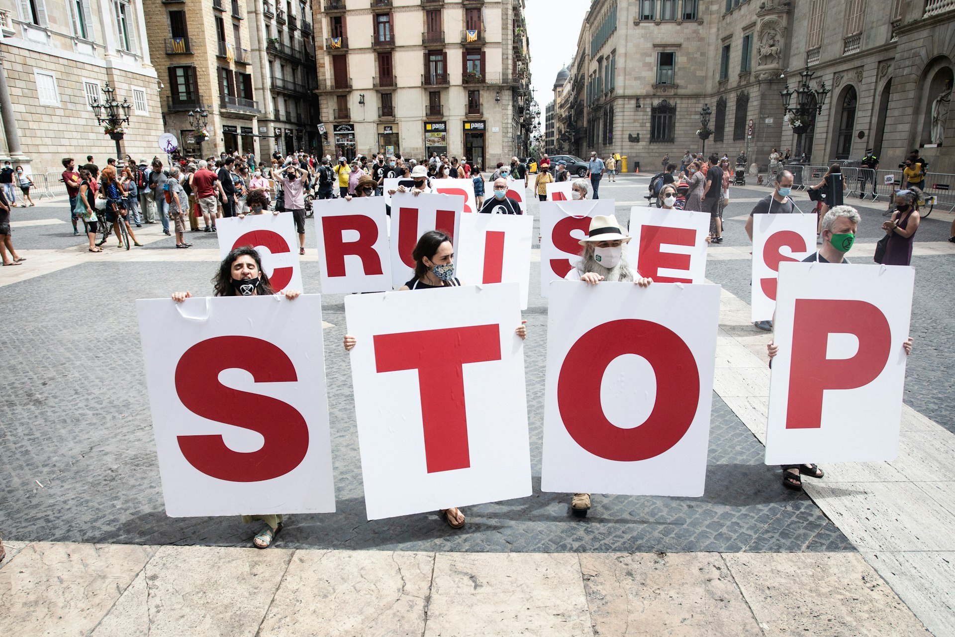 Protesters with STOP CRUISES BCN placards in Barcelona, Catalonia, Spain