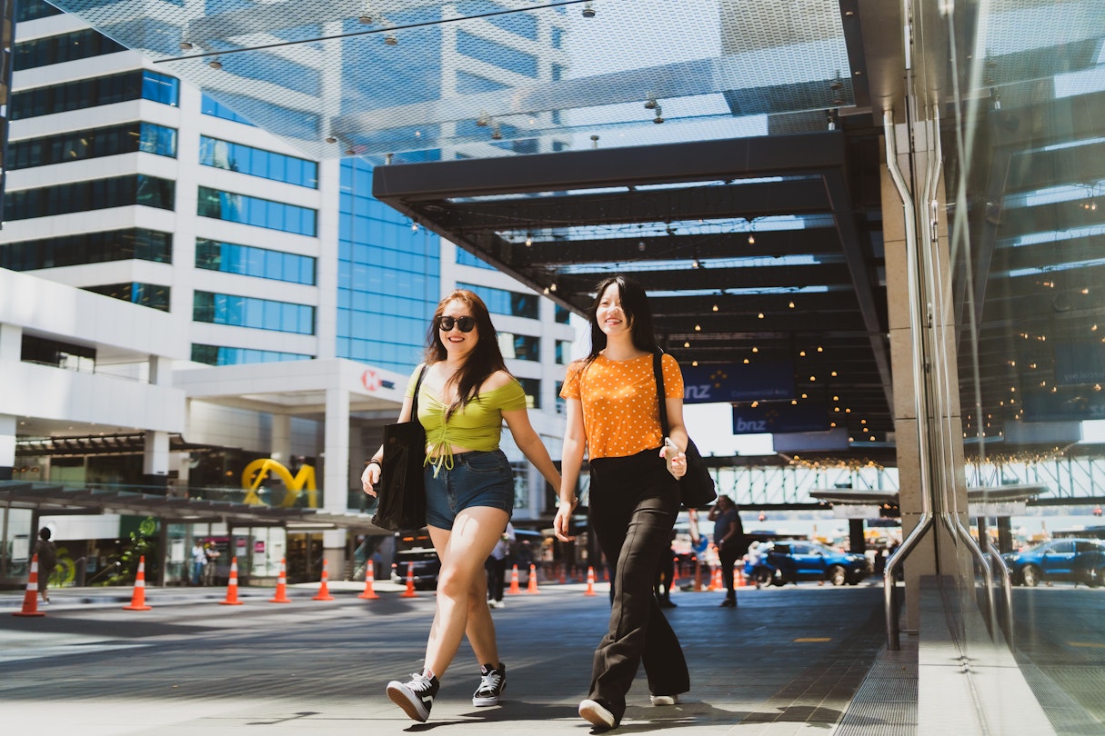 Two friends walking through the city. - stock photo
The portrait of two happy confident women very excited and walking through the city.