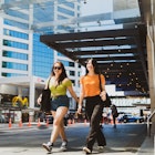 Two friends walking through the city. - stock photo
The portrait of two happy confident women very excited and walking through the city.