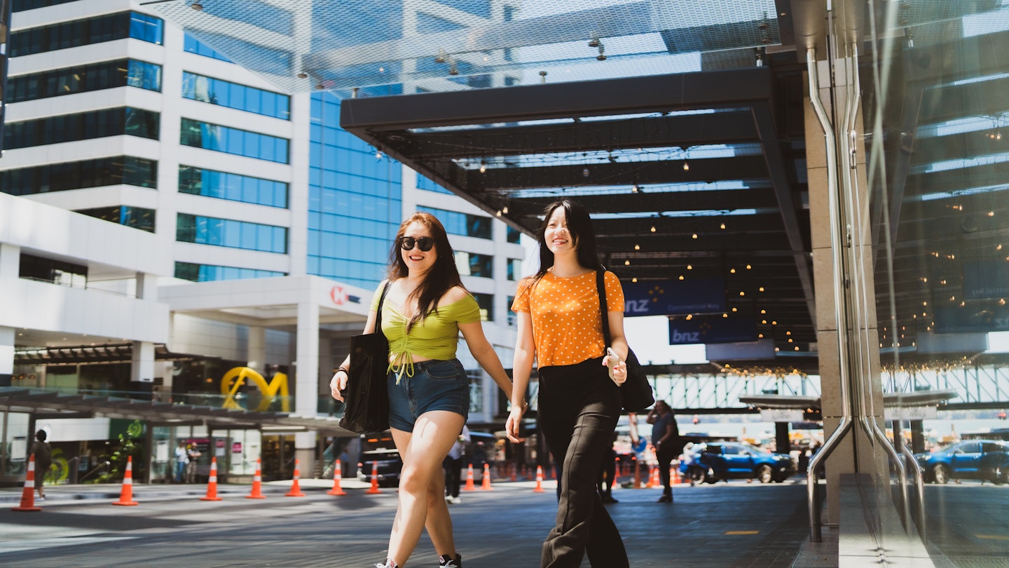 Two friends walking through the city. - stock photo
The portrait of two happy confident women very excited and walking through the city.