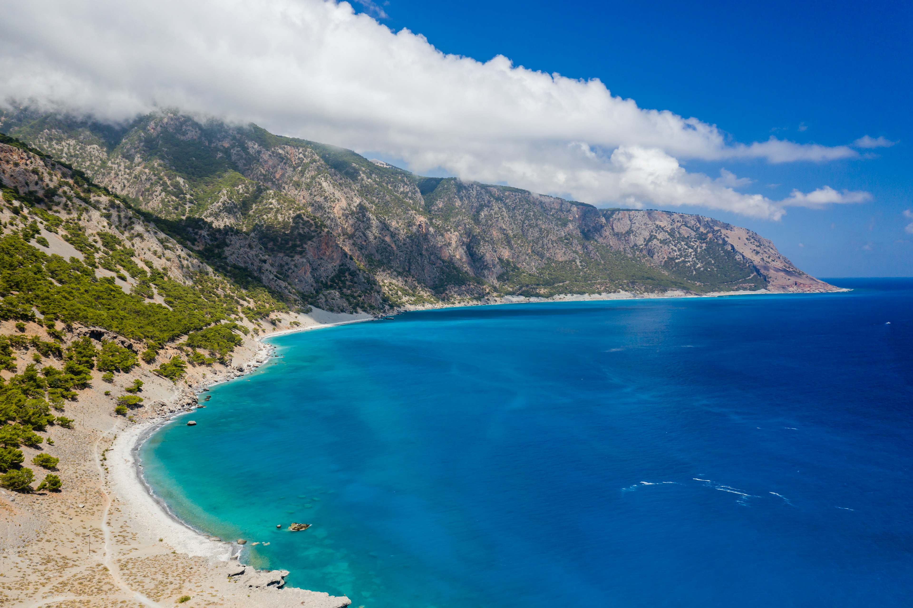 Aerial view of clouds over large mountains on a coastline, Agia Roumeli, Crete, Greece