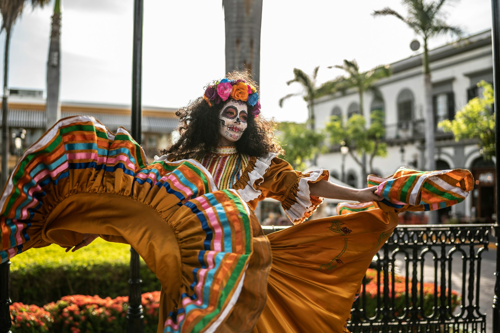 Middle aged adult woman dancing and celebrating the day of the dead in mexico full day of the dead sostume