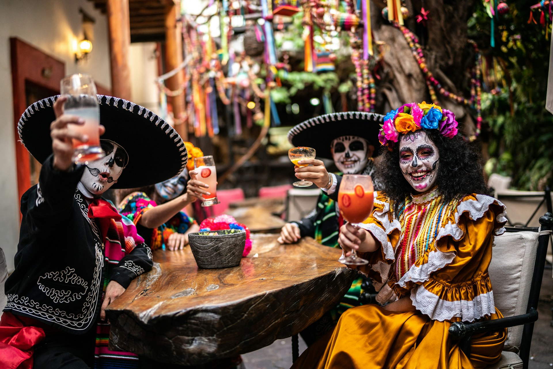 A group of friends in full make up celebrating the Day of the Dead at a bar in Mexico