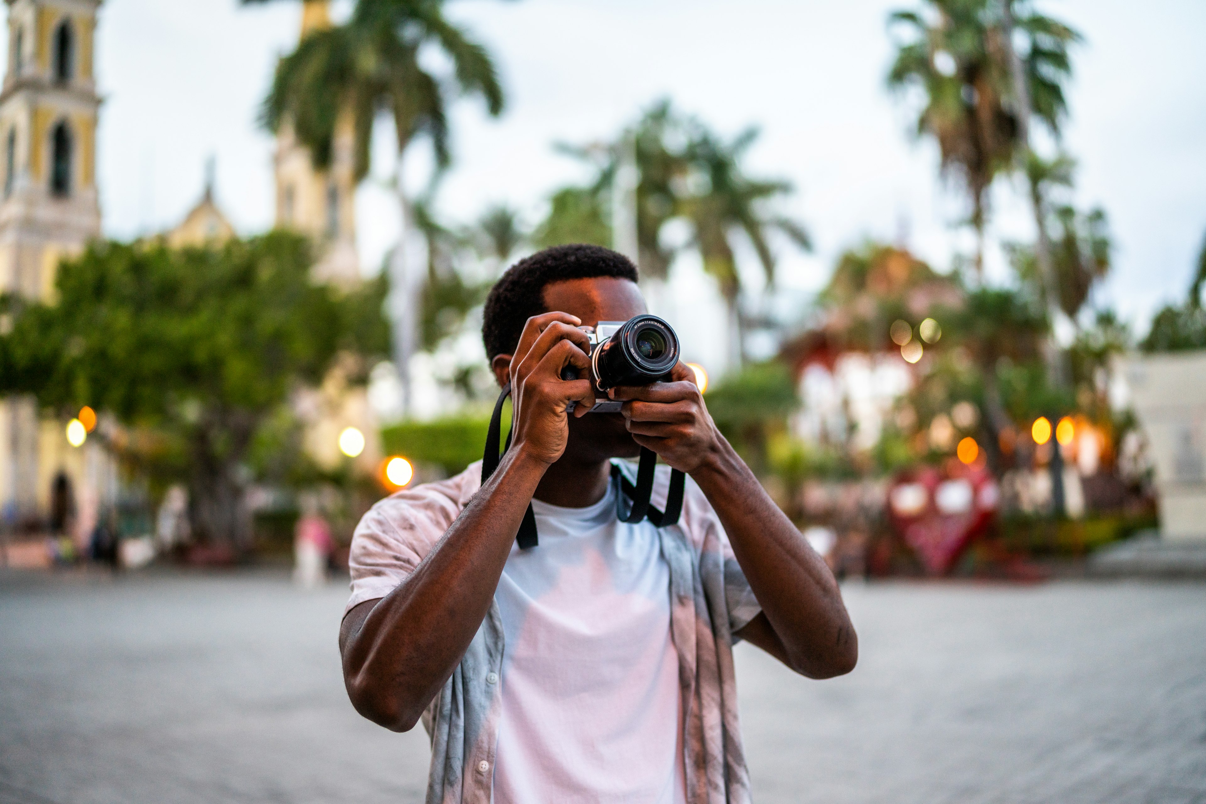 A man takes a photo in a historic square