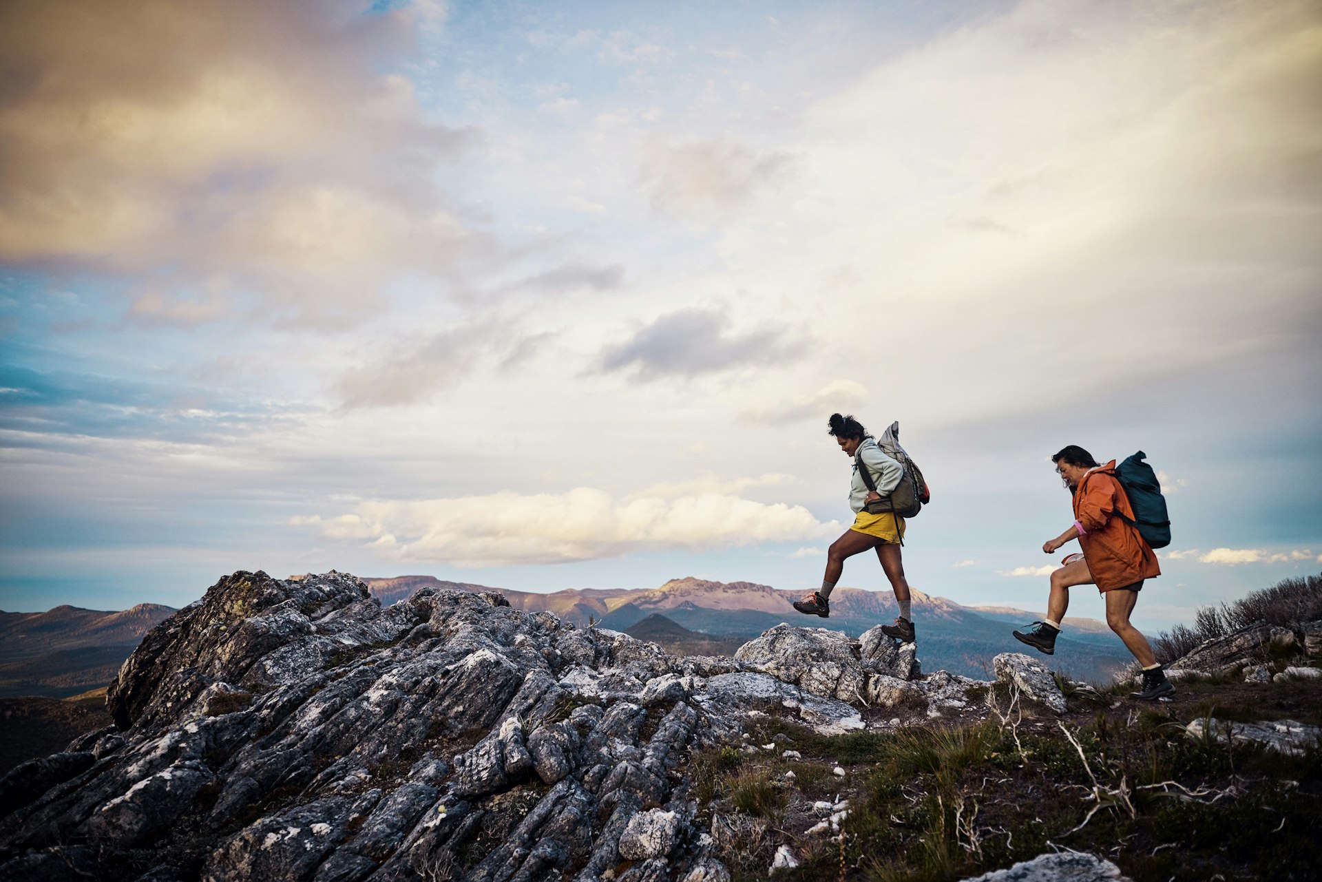 Adventurous women following a hiking trail along a rocky outcrop 