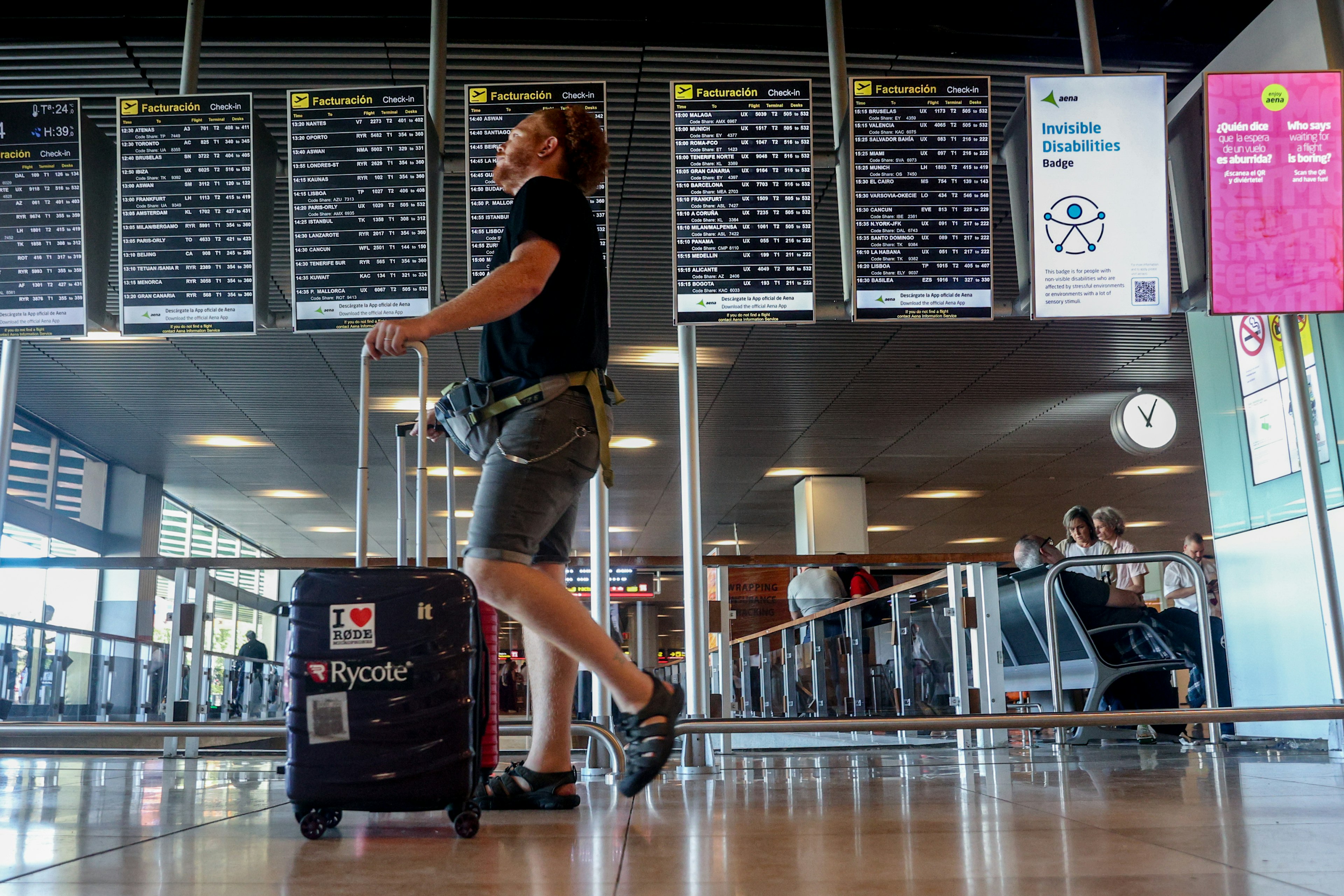 A man with a suitcase at Barajas airport, Madrid Spain