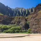 A young couple enjoys the peaceful solitude at Kalalau Beach on the Napali Coast in Kauai, Hawaii.
1610992595
Strolling along Kalalau Beach on the Napali Coast in Kauai, Hawaii - stock photo
A young couple enjoys the peaceful solitude at Kalalau Beach on the Napali Coast in Kauai, Hawaii.